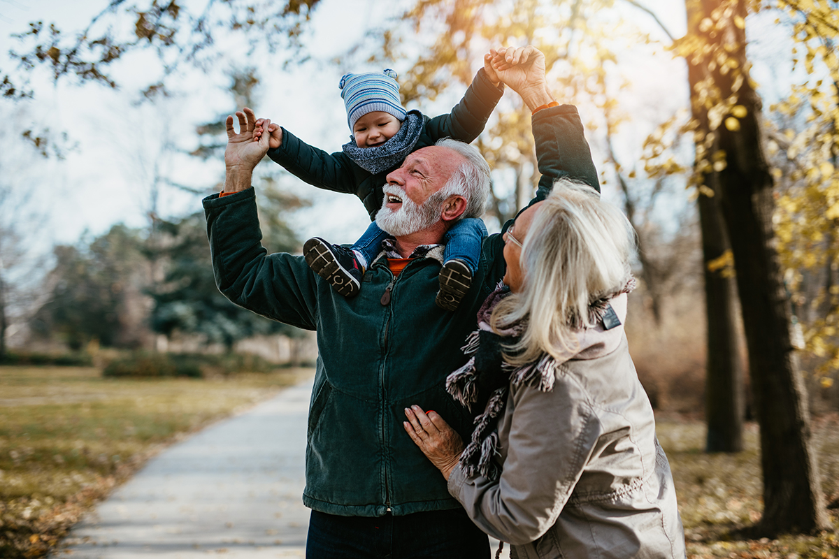 Older couple having fun with grandchild because they found Welch Financial Planning for retirement  planning