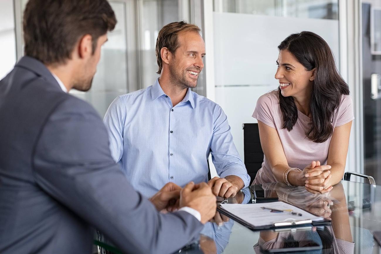 Middle-aged couple meeting with Colorado financial planning firm