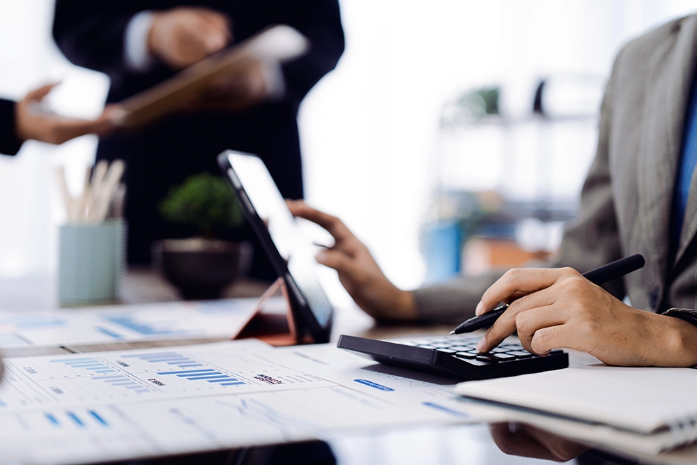 Financial advisor reviewing tax planning documents and investment charts.